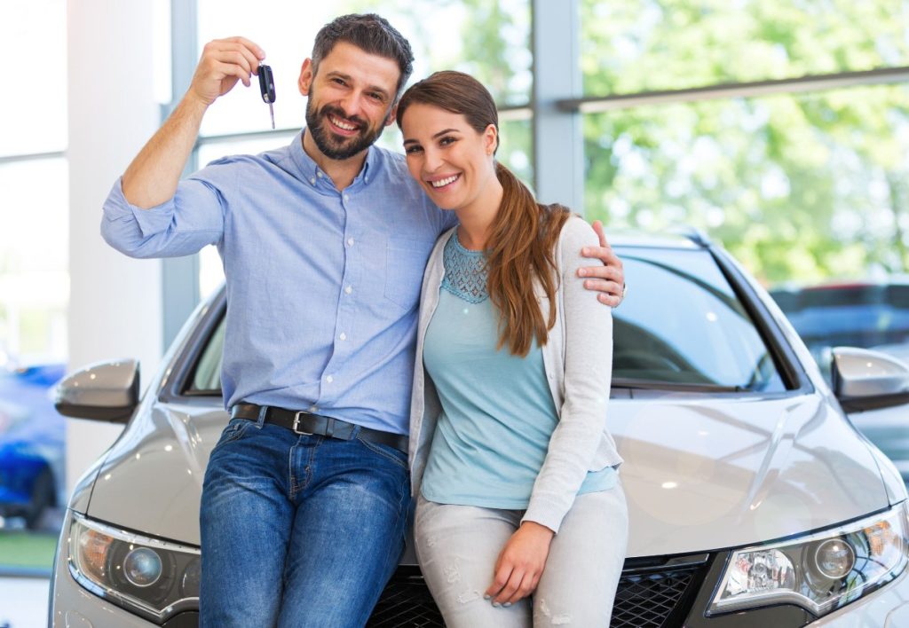 Couple at car dealership