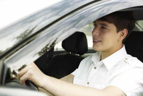 teen driver with white shirt, selective focus on nearest eye