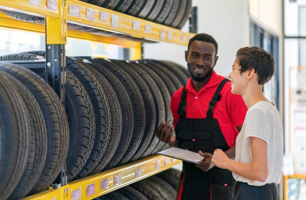 People in front of rack of tires