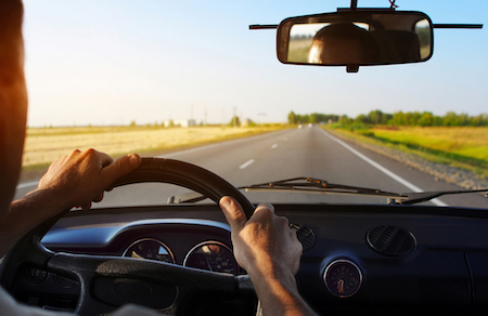 Drivers's hands on stearing wheel of a car