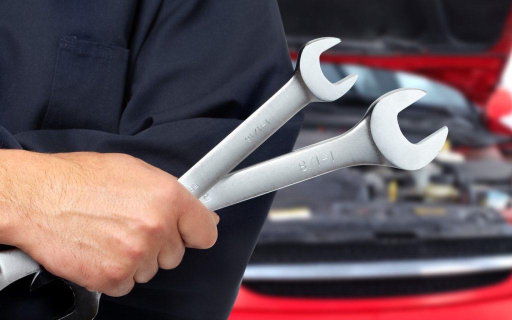 Service Tech holding wrenches