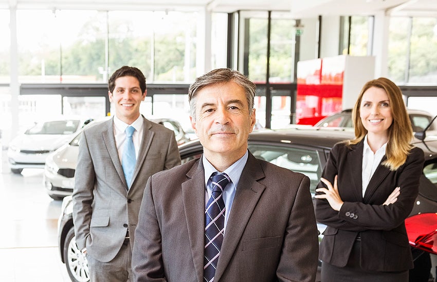 People standing in car showroom